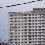 A graffiti saying "Naddle und Ronny siegt" on top of an old gdr building.