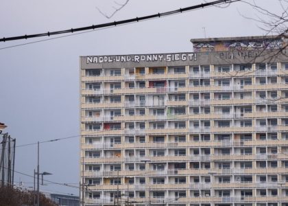 A graffiti saying "Naddle und Ronny siegt" on top of an old gdr building.